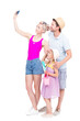 © Mediaphotos - Vertical full length studio portrait of family with one little daughter wearing summer outfits spending time on vacation, white background