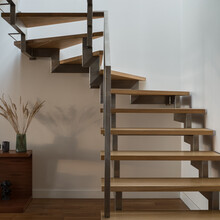 Close-up On Modern Wooden Stairs With Silver Railing