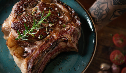 Wall Mural - Tomahawk on a plate with garnish food photography recipe idea