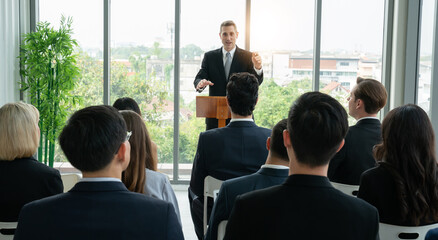 a man leader giving a talk in business event. group of business people workshop training at seminar room.