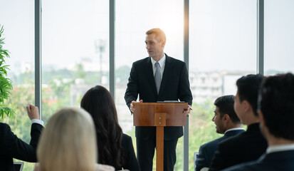 a man leader giving a talk in business event. group of business people workshop training at seminar room.