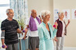 © Rido - Group of active seniors exercising together at gym