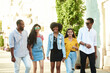 © etonastenka - A group of friends of different nationalities walk around the city and look at the camera