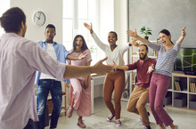 Congratulations: Diverse Group Of Excited Young People Meet Man Who's Achieved Great Success. Long Time No See: Happy, Emotional Friends Spread Arms Wide Open To Hug Friend Who's Finally Back Home