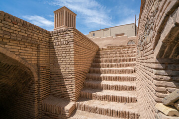 Wall Mural - View from under an old wind catcher, or cooling tower, in ancient city of Naein, Iran, Persia, on a hot summer day