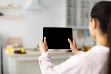 Poster - Lady using digital tablet with blank empty screen, mock up