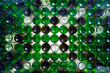 © Anna - Stacked glass bottles of different colors, viewed from the bottom