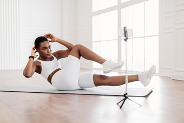 Wall Mural - Black Woman Doing Twist Crunches Exercise On Camera