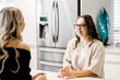 © Austockphoto - young women talking in kitchen, one sister has Down Syndrome
