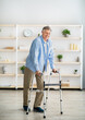 © Prostock-studio - Full length portrait of elderly man walking with frame at retirement home. Limited excursion in elderly people