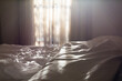 © Austockphoto - Light through a bedroom window onto a unmade bed