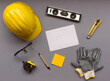 top view design engineering and construction concept on grey background with tools, white paper, safety helmet, gloves, pencil, measurement and top view with copy space, work space, civil engineering