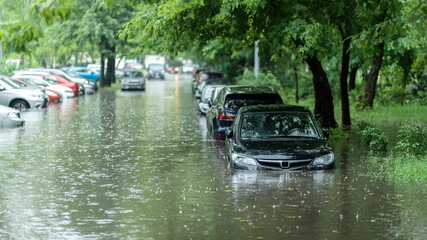 flooded cars on the street of the city. street after heavy rain. water could enter the engine, trans