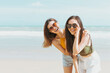 © JR-50 - Two women friends in summer casual clothes Take a photo together at the beach