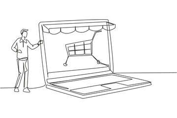 Poster - Single continuous line drawing young man inserting credit card into canopy laptop screen with shopping cart. E-shop, digital payment concept. Dynamic one line draw graphic design vector illustration