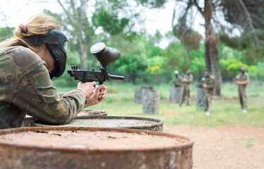 Poster - Team of friends paintball players playing together in battle in forest