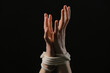 Female hostage with tied hands on dark background, closeup
