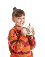 Wall Mural - Little girl with cup of hot cocoa on white background