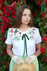 Wall Mural - Russian fashion woman, pretty girl in rose garden. Retro look with handmade collar with embroidery, skirt. Street style, lady like style. Summer trendy outfit. Embroidered vintage collar. Retro look