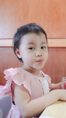 Wall Mural - Charming 2-3 years old cute baby Asian girl, little toddler child pout lips looking at camera.