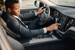 © Fxquadro - Black businessman inside car using car panel