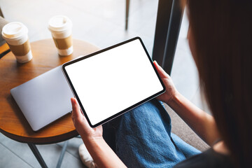 Mockup image of a woman holding digital tablet with blank white desktop screen