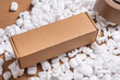 © mdbildes - Cardboard box on loose white Filler Shipping Packing Peanuts