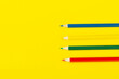 school supplies on a yellow background, top view