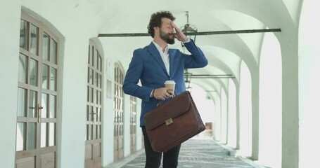 Poster - upset smart casual fashion model with coffee and suitcase, reacting, throwing coffee and getting on knees, negatively reacting to god against city background