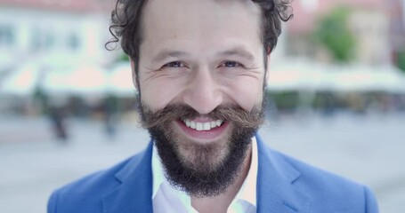 Poster - curly hair man with long moustache posing outdoor in medieval city being happy, smiling and laughing