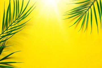 Yellow summer background with palm leaves-the theme of the beach, tropical holidays, hot sun. Frame, copy space.