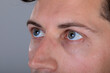 © WavebreakMediaMicro - Close up of blue eyes of caucasian businessman, isolated on grey background