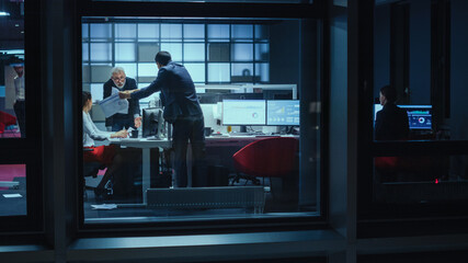 Poster - Shot from Outside the Window: Business Meeting Goes Out of Hand When Managers Start to Argue Over Financial Charts and Stock Prices. Crisis Reaches Peak when Employee Throws Papers in the Air.