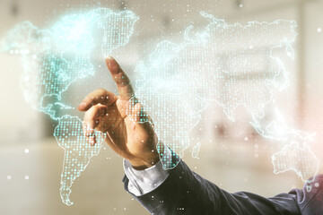 Poster - Man hand working with abstract creative world map interface on blurred office background, international trading concept. Multiexposure