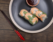 Vietnamese Prawn Shrimp See Through Rice Paper Spring Roll Green Vegetable Sauce On Dark Plate Chopsticks Wooden Table