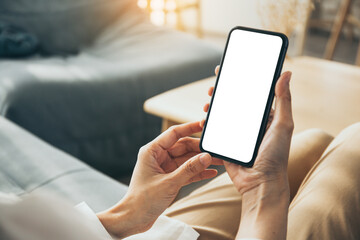 cell phone blank white screen mockup.woman hand holding texting using mobile on desk at office.backg