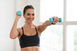 © Prostock-studio - Happy Sporty Woman Exercising With Two Dumbbells And Posing