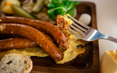 Close up of man eating sausages. Free space for text. Traditional Hungarian food