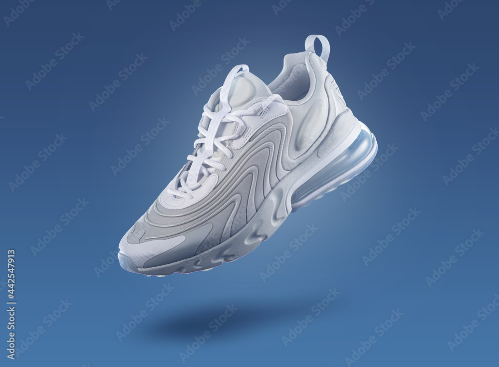 White sneaker on a blue gradient background, men's fashion, sport shoe, nike air max, sneakers, lifestyle, concept, product photo, adidas, puma, veya, new balance, Asics, levitation concept  - obrazy, fototapety, plakaty 