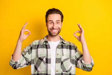 Wall Mural - Photo of young man happy positive smile show okay deal cool advise sign isolated over yellow color background