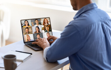 Wall Mural - Teleconference Concept. Businessman Joined Video Call With Colleagues On Laptop In Office