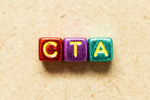 Metallic Color Alphabet Letter Block In Word CTA (Abbreviation Of Call To Action Or Chartered Tax Adviser) On Wood Background