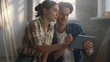 © stockbusters - Smiling couple searching pictures with house interiors on tablet indoors.