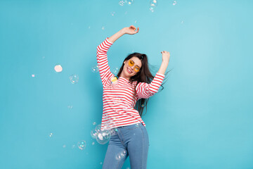 Sticker - Portrait of attractive carefree dreamy cheerful girl dancing bubbles flying good mood isolated over bright blue color background