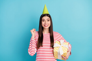 Sticker - Portrait of attractive girlish cheerful girl holding gift having fun rest cool event isolated over bright blue color background