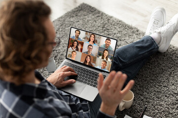 Wall Mural - Young Freelancer Guy Having Web Conference With Colleagues With Laptop At Home