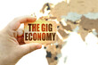 Against the background of the world map, a man holds a sign with the inscription - The gig economy