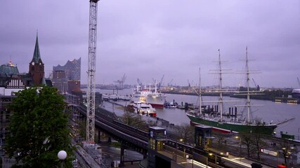 Wall Mural - Famous St Pauli Landungsbruecken at the port of Hamburg - amazing evening view - travel photography