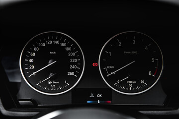 Wall Mural - Speedometer arrows in dark colors in a car.