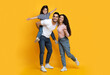 © Prostock-studio - Cheerful Middle Eastern Family Of Three Having Fun Together Over Yellow Background